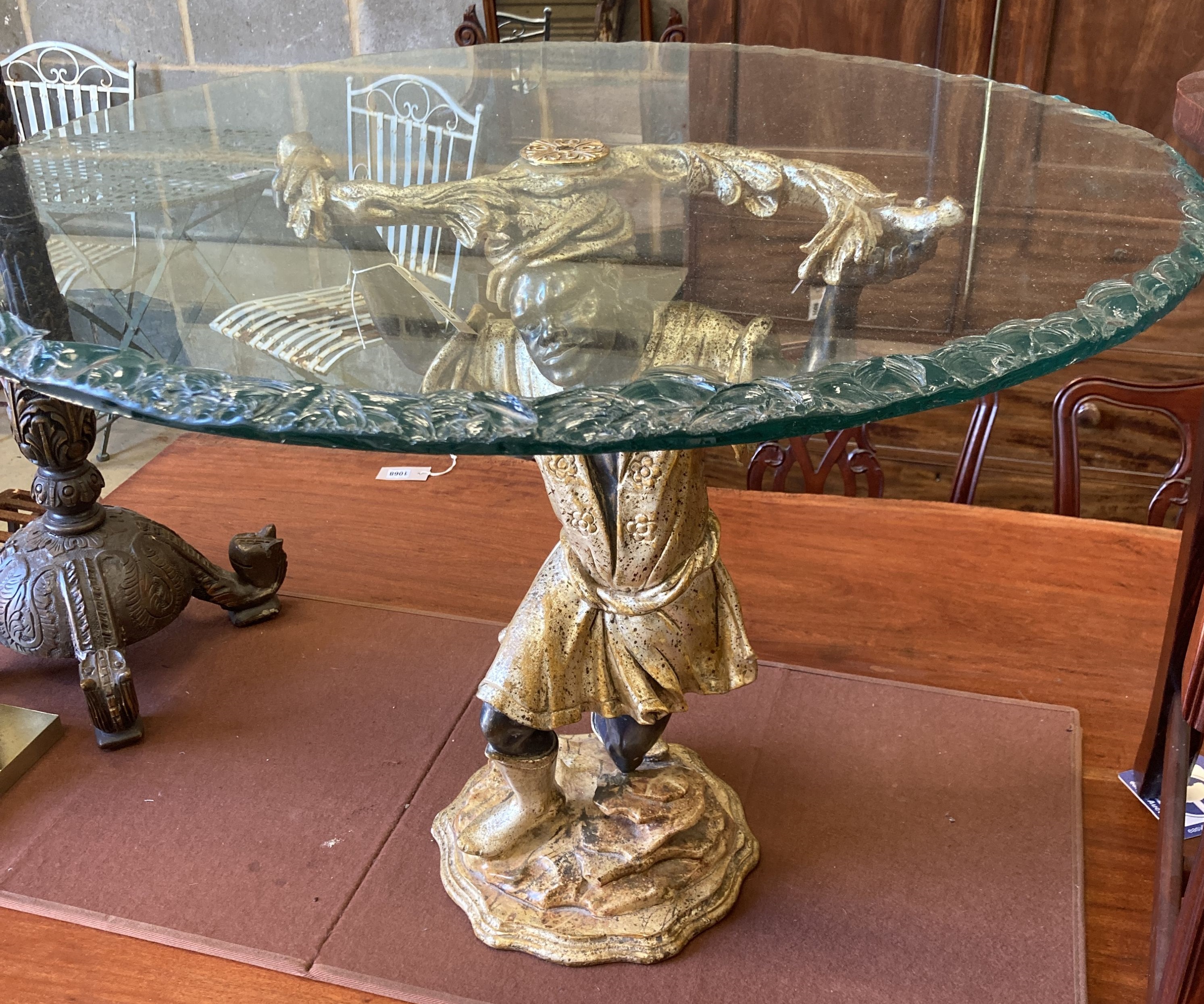 A reproduction Blackamoor table with circular glass top, diameter 80cm, height 63cm